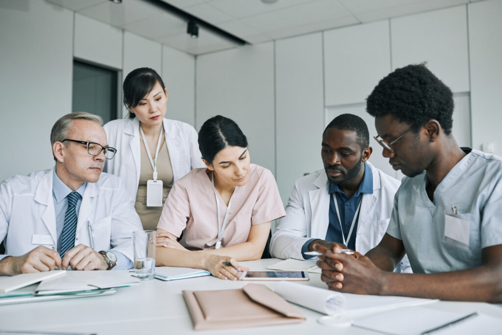 Diverse Group of Doctors Communicating in Meeting